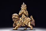 A GILT BRONZE FIGURE OF MANJURI ON LION