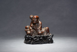 AN AGARWOOD SEATED 'TAMING TIGER' LUOHAN