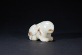 A WHITE JADE MYTHICAL BEAST WITH SKIN