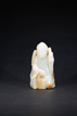 A WHITE JADE CARVED FIGURE WITH SKIN