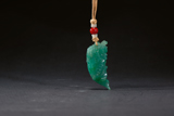 A RICH GREEN JADEITE 'CARP' PENDANT