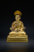 A GILT-BRONZE FIGURE OF GURU