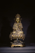 A GILT-BRONZE GUANYIN UPON LOTUS