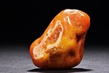 A NATURALISTIC CARVED AMBER