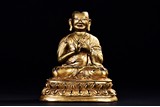 A GILT-BRONZE FIGURE OF GURU