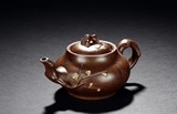 A YIXING ZISHA PLUM TEAPOT