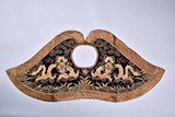 AN EMBROIDERED DRAGON SHOULDER CAPE