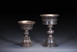 A GROUP OF TWO TIBETAN SILVER BUTTER LAMPS