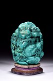 A TURQUOISE CARVED 'DEEP MOUNTAIN' BOULDER