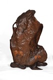 A LARGE BURLWOOD CARVED BOULDER