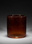 AN AMBER GLASS GOLD-SPLASHED BRUSHPOT
