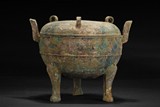 AN ARCHAIC BRONZE TRIPOD CENSER
