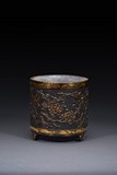 A PARCEL GILT BRONZE 'PLUM BLOSSOM' TRIPOD CENSER