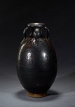 A BLACK GLAZED FOUR-EAR JAR