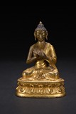 A GILT-BRONZE FIGURE OF SHAKYAMUNI