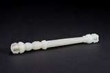 A WHITE JADE CARVED TIBETAN SKULL CLUB