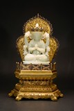 A WHITE JADE BODHISATTVA WITH GILT-BRONZE STAND