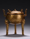 A GILT-BRONZE BRONZE TRIPOD CENSER