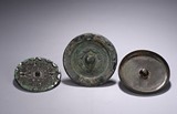 A SET OF THREE BRONZE MIRRORS