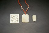 A SET OF THREE WHITE JADE ORNAMENTS