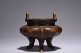A BRONZE TRIPOD CENSER