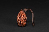 A SMALL WALNUT CARVED 'FIGURES' ORNAMENT