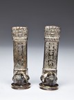 A PAIR OF SILVER TURTLE SUPPORTED STELES