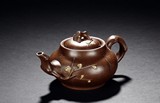 A YIXING ZISHA PLUM TEAPOT