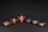 A SET OF SIX ZISHA TEAPOTS