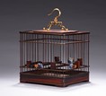 A SQUARE ROSEWOOD CARVED BIRD CAGE