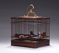 A SQUARE ROSEWOOD CARVED BIRD CAGE