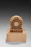 AN ANTIQUE BONE CARVED DHARMACAKRA SEAL