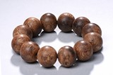 A TWELVE BEAD AGARWOOD BRACELET
