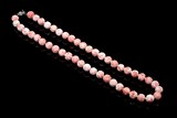 A CORAL CARVED BEAD NECKLACE