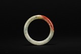 A BI-COLORED JADEITE BANGLE