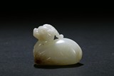 A CARVED WHITE JADE MYTHICAL BEAST