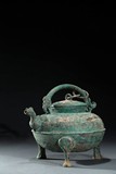 A BRONZE RITUAL TRIPOD HE EWER AND COVER
