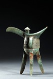 A BRONZE RITUAL TRIPOD WINE JUE VESSEL