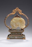 A CARVED WHITE JADE ELEPHANT WITH CLOISONNE ENAMEL STAND