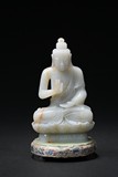 A WHITE JADE STATUE OF SHAKYAMUNI