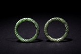 A PAIR OF SMALL GREEN JADE BANGLES