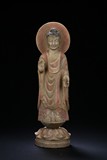 A STONE CARVED STANDING BODHISATTVA