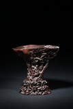AN AGARWOOD CARVED 'FIGURES' LIBATION CUP
