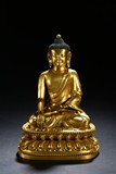 A GILT BRONZE FIGURE OF SHAKYAMUNI