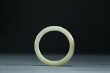 A YELLOW CELADON JADE BANGLE