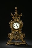 AN ANTIQUE BRONZE CLOCK
