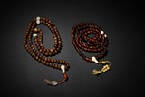 A SET OF TWO AMBER AND JICHIMU PRAYER'S BEADS
