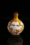A WHITE OVERLAY YELLOW GLASS 'PALACE' SNUFF BOTTLE