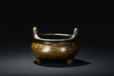A BRONZE TRIPOD CENSER