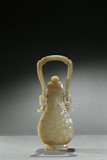 A WHITE JADE 'ARCHAISTIC BEAST' HU WITH HANDLE